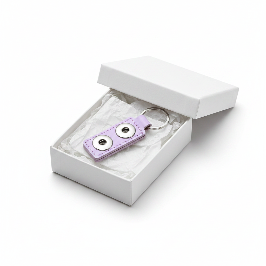 A light purple faux leather keychain with two silver snap buttons and a silver split key ring, shown on a white background.