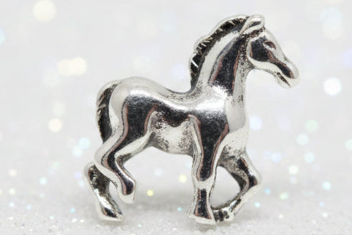 A small metallic silver horse charm with a polished, reflective finish, shown against a dark black background.