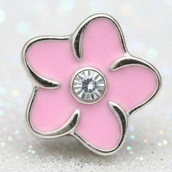 A pink flower-shaped charm with silver metal edges and a clear rhinestone in the center, locket charm