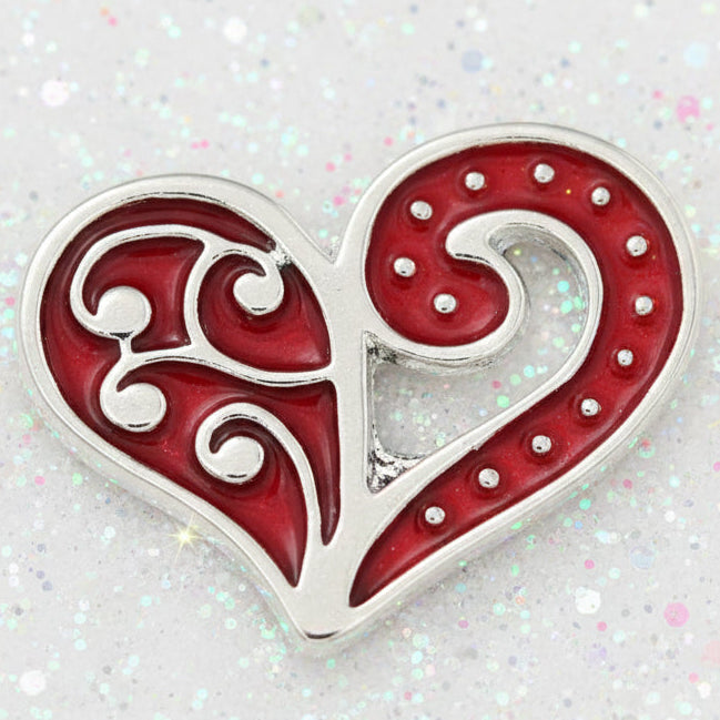 A heart-shaped charm with a red and white swirl pattern, featuring a small silver-toned cross in the center, shown on a plain white background.