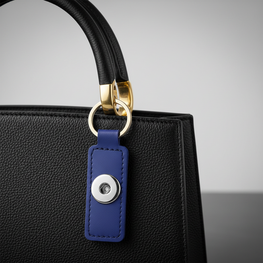 A deep blue leather keychain with a snap closure, designed to fit Statement Snaps.