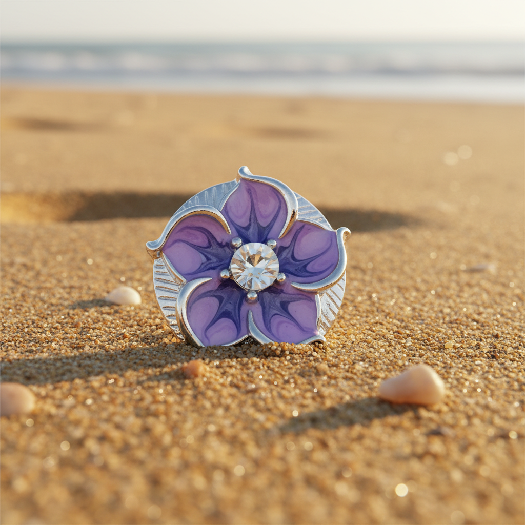 A single flower-shaped snap button with purple enamel petals, a silver-toned metal border, and a clear round center stone, photographed on a soft white background with subtle bokeh and glitter.