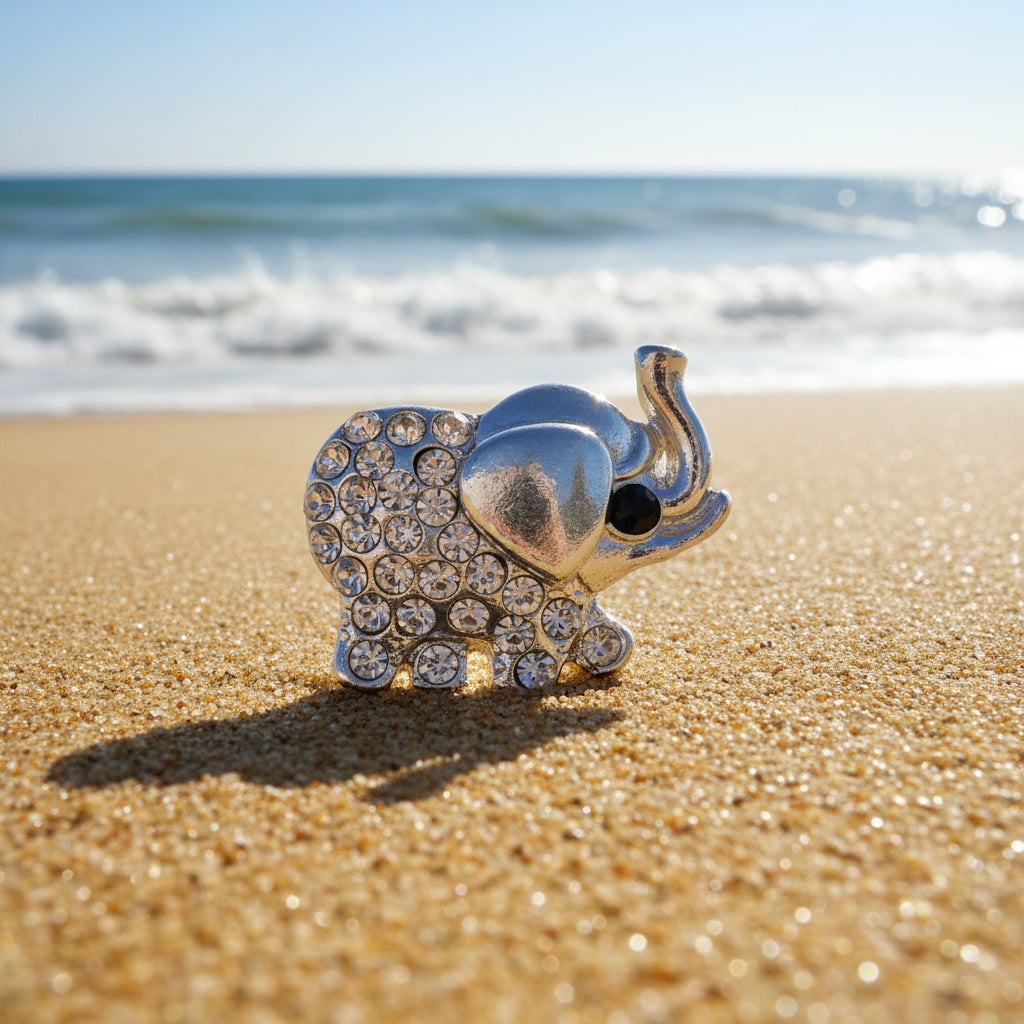 A silver-toned elephant-shaped snap button embellished with clear rhinestones and featuring a small black eye, shown on a plain white background.