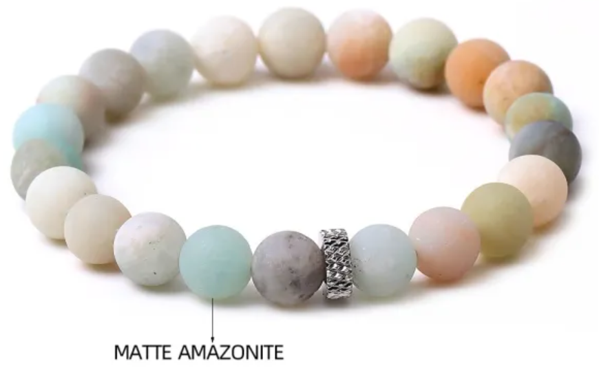 A beaded bracelet with light blue, gray, and beige round beads and a small silver patterned accent.