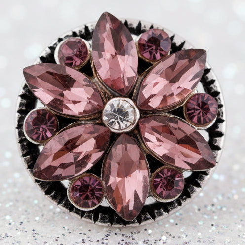 A round floral snap button featuring faceted dusty rose and burgundy marquise and round crystals set in a silver-tone metal border with a clear crystal at the center.