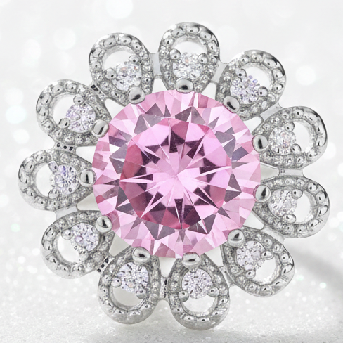 A floral cluster snap button featuring a large round pink center stone surrounded by smaller clear stones in silver-toned settings, isolated on a white background.