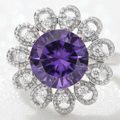 A floral-shaped silver snap button featuring a large round purple gemstone in the center, surrounded by multiple small clear round-cut stones in openwork circular petal-like settings.